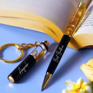 “Personalized gold flake pen and keychain set with name engraved, packed in a premium gift box – perfect for birthdays, corporate or personal gifting.”