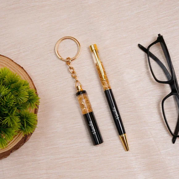“Personalized gold flake pen and keychain set with name engraved, packed in a premium gift box – perfect for birthdays, corporate or personal gifting.”