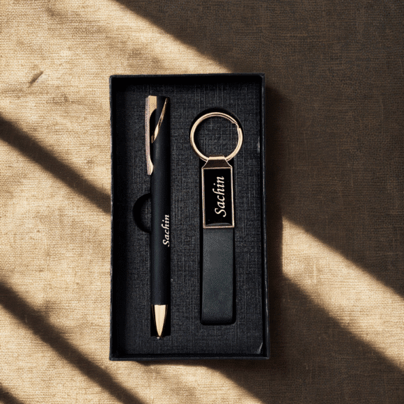 “Luxury matte black and rose gold pen and keychain gift set in premium grey presentation box – elegant gift for professionals or corporate use.”