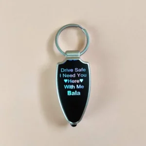 “Drive Safe LED keychain in multicolor with custom name engraving, compact design for bike, car, or couple key holders – ideal gift with LED light feature.”